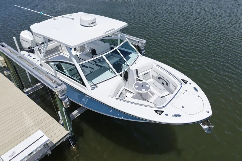 Slide: The Image of 2023 Blackfin 272 DC boat docked on water, showcasing sleek design and modern features. - 5