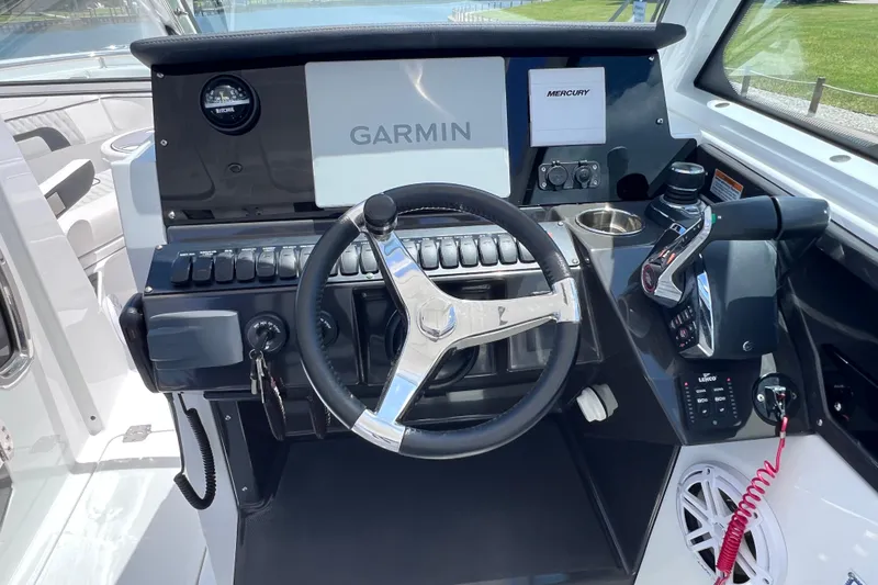 Slide: The Image of 2023 Blackfin 272 DC boat dashboard with Garmin and Mercury controls. - 52