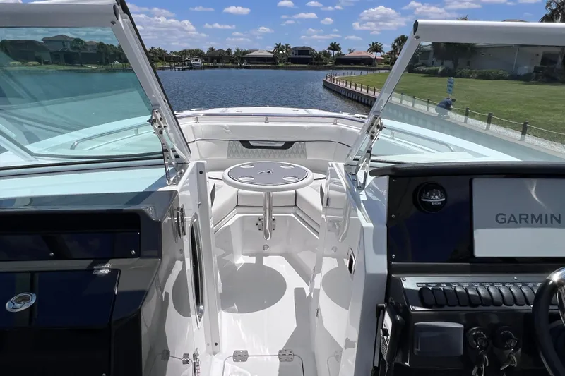 Slide: The Image of 2023 Blackfin 272 DC boat interior with open windshield and Garmin navigation system. - 54