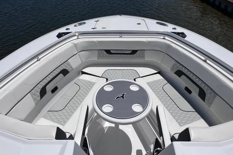 Slide: The Image of 2023 Blackfin 272 DC boat interior with luxurious seating and table on the water. - 55