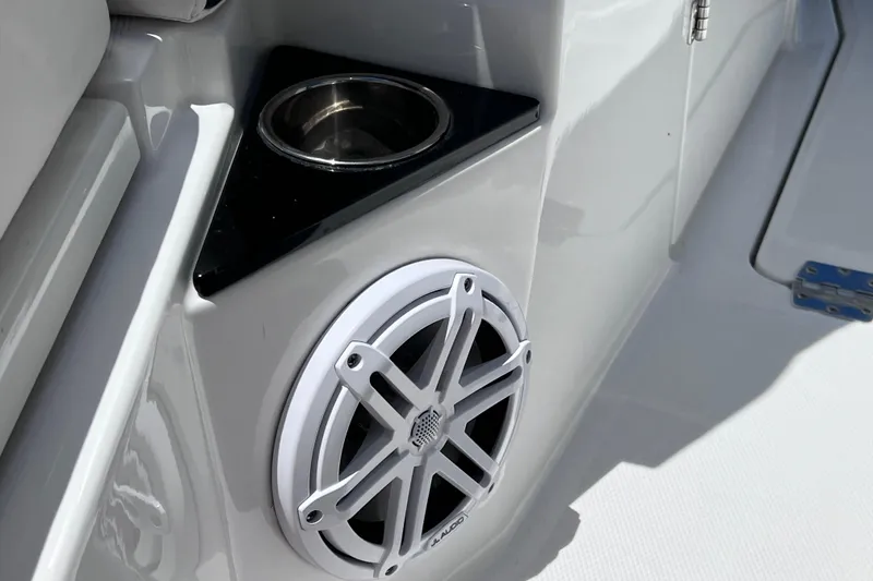Slide: The Image of Cup holder and speaker on 2023 Blackfin 272 DC boat interior. - 58
