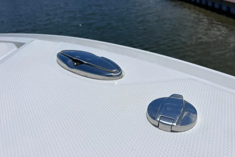 Slide: The Image of Close-up of 2023 Blackfin 272 DC boat deck fittings by the water. - 60