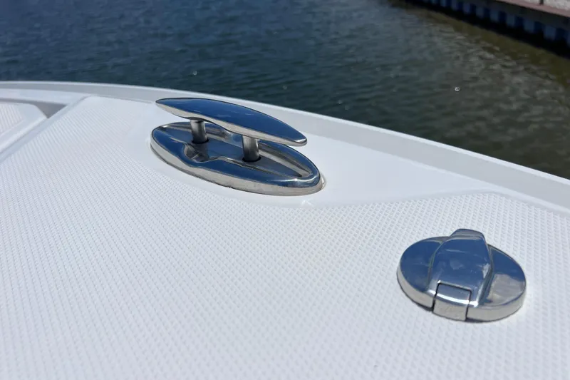Slide: The Image of Close-up of 2023 Blackfin 272 DC boat cleat and deck hardware by the water. - 61