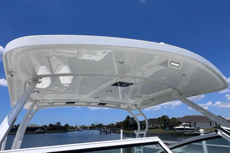 Slide: The Image of 2023 Blackfin 272 DC boat canopy against a clear blue sky. - 67