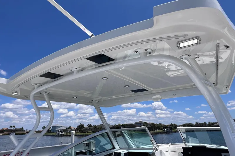 Slide: The Image of 2023 Blackfin 272 DC boat canopy with LED lights against a clear blue sky. - 68