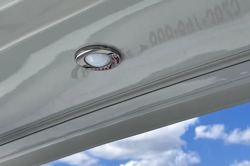 Slide: The Image of LED light on 2023 Blackfin 272 DC boat ceiling against blue sky background. - 69