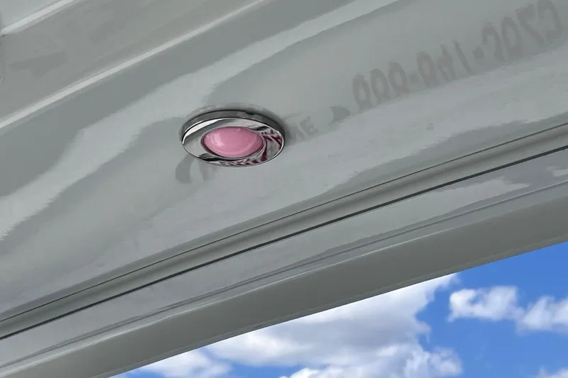 Slide: The Image of 2023 Blackfin 272 DC boat ceiling with pink LED light against blue sky. - 70