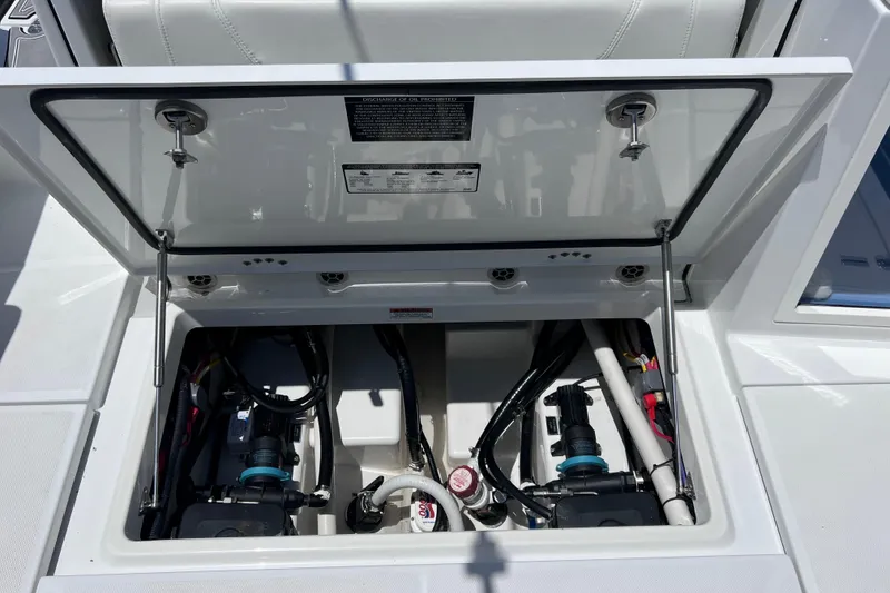 Slide: The Image of Open hatch of 2023 Blackfin 272 DC boat showing internal components and wiring. - 72