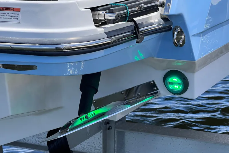 Slide: The Image of 2023 Blackfin 272 DC boat stern with green underwater lights and trim tabs. - 77