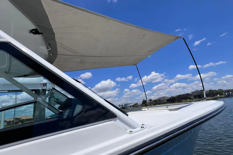 Slide: The Image of 2023 Blackfin 272 DC boat with canopy on a sunny day by the water. - 84