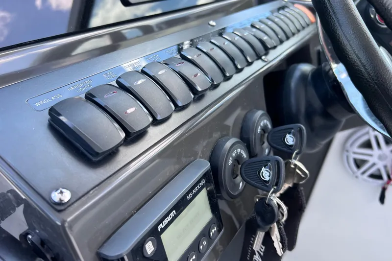 Slide: The Image of Control panel of 2023 Blackfin 272 DC boat with switches and keys. - 91