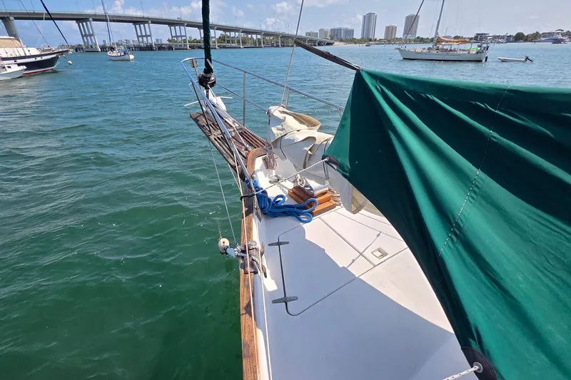 Slide: The Image of 1987 Gozzard 36 Cruiser sailboat on water, bridge and city skyline in background. - 13