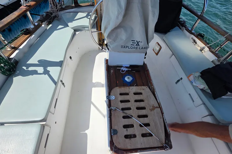 Slide: The Image of 1987 Gozzard 36 Cruiser cockpit with seating, steering wheel, and covered equipment. - 20