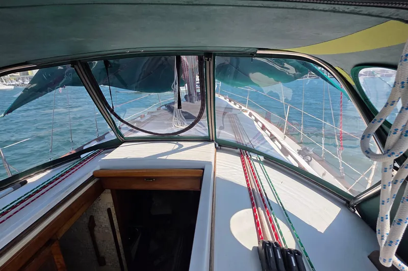 Slide: The Image of Interior view of 1987 Gozzard 36 Cruiser sailboat with ropes and ocean backdrop. - 25