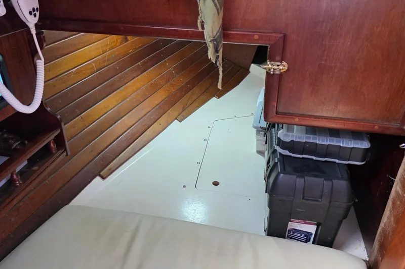Slide: The Image of Interior of 1987 Gozzard 36 Cruiser with wooden paneling and storage boxes. - 29