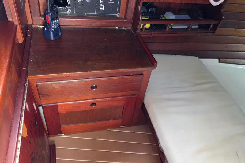 Slide: The Image of Interior of 1987 Gozzard 36 Cruiser with wooden cabinetry and cushioned seating. - 32
