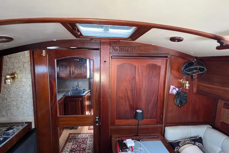 Slide: The Image of Interior of 1987 Gozzard 36 Cruiser with wood paneling and nautical decor. - 34