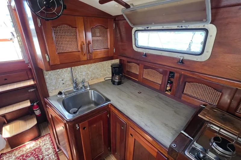 Slide: The Image of 1987 Gozzard 36 Cruiser galley with wooden cabinetry and stainless steel sink. - 37
