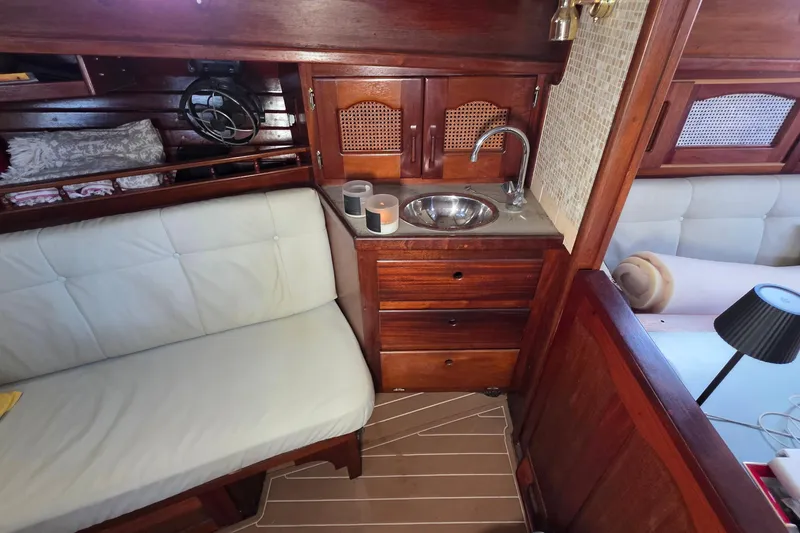 Slide: The Image of Interior of 1987 Gozzard 36 Cruiser with wooden cabinetry and compact sink area. - 40