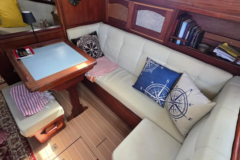 Slide: The Image of Cozy interior of 1987 Gozzard 36 Cruiser with nautical-themed cushions and wooden furnishings. - 41