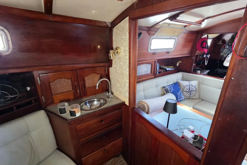 Slide: The Image of Interior of 1987 Gozzard 36 Cruiser with wooden cabinetry and cozy seating area. - 42