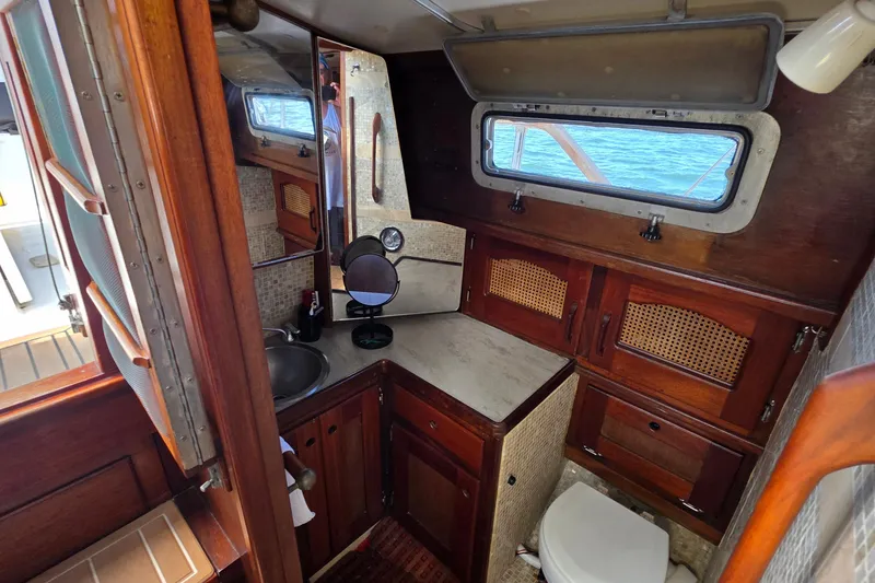 Slide: The Image of Interior of 1987 Gozzard 36 Cruiser with wooden cabinetry and nautical decor. - 43