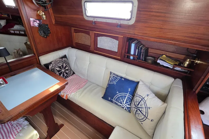 Slide: The Image of Cozy interior of 1987 Gozzard 36 Cruiser with nautical-themed cushions and wooden accents. - 45