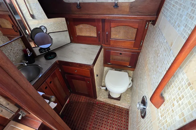 Slide: The Image of 1987 Gozzard 36 Cruiser bathroom with wooden cabinets and compact design. - 46