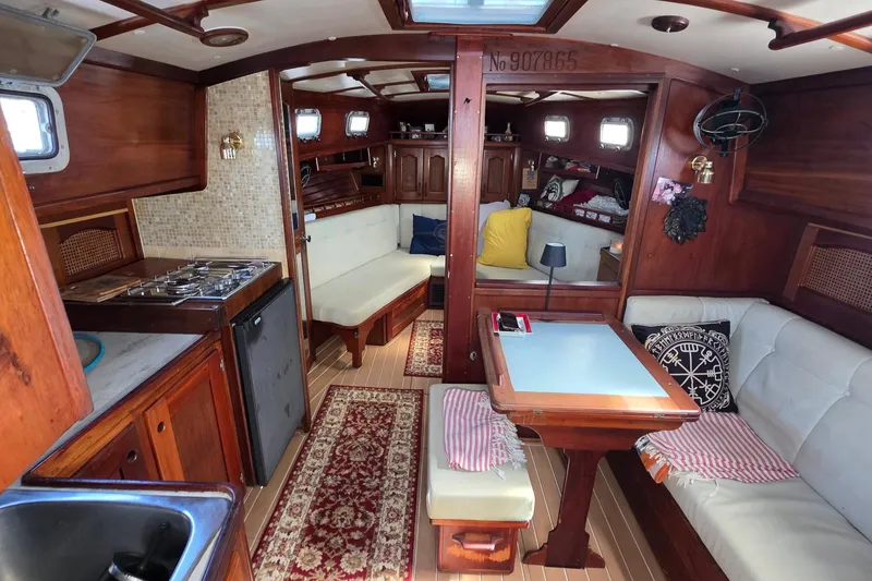 Slide: The Image of Interior of 1987 Gozzard 36 Cruiser yacht with wooden furnishings and cozy seating. - 53
