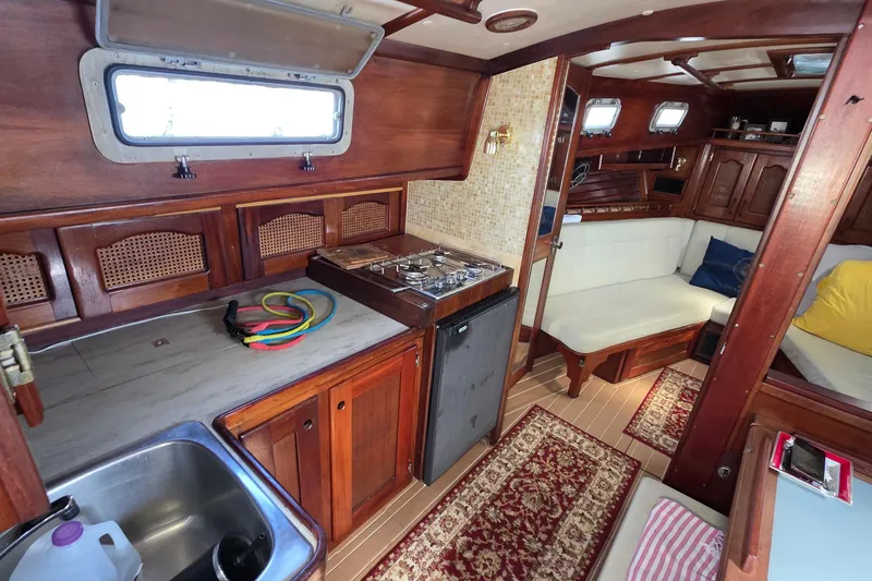 Slide: The Image of Interior of 1987 Gozzard 36 Cruiser with wooden cabinetry and cozy seating area. - 55