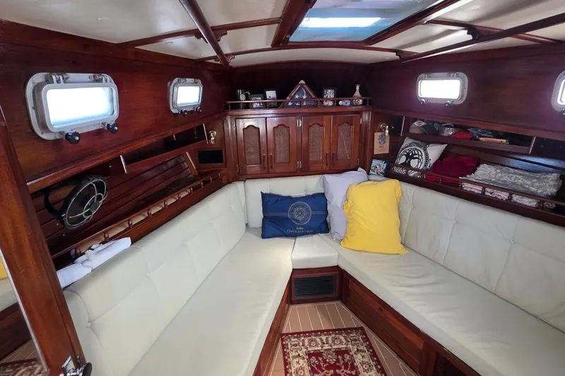 Slide: The Image of Interior of 1987 Gozzard 36 Cruiser with cozy seating and wooden cabinetry. - 58