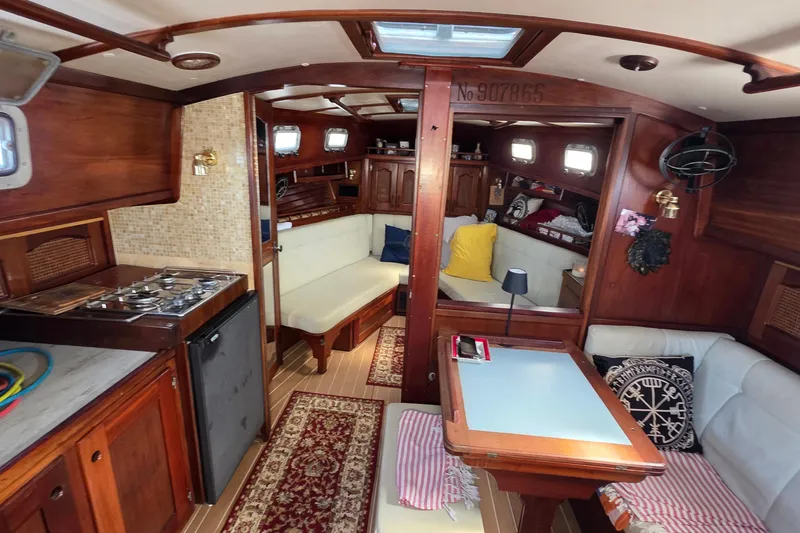 Slide: The Image of Interior of 1987 Gozzard 36 Cruiser yacht with cozy seating and wooden finishes. - 59