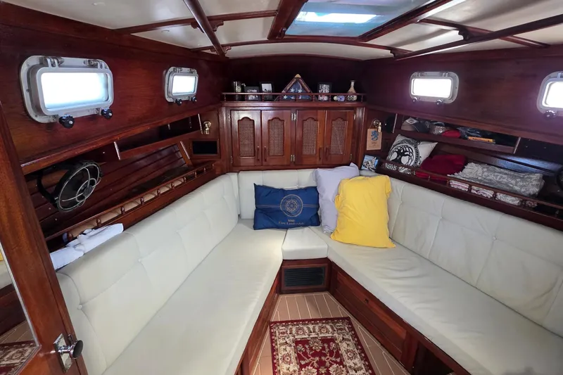 Slide: The Image of Interior of 1987 Gozzard 36 Cruiser with cozy seating and wooden cabinetry. - 60