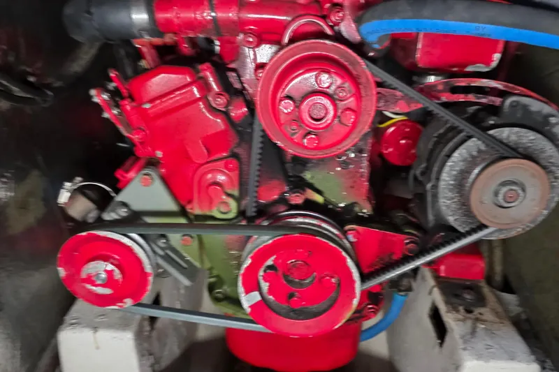 Slide: The Image of Red engine of a 1987 Gozzard 36 Cruiser with visible belts and components. - 7