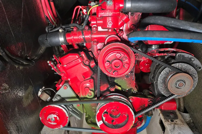 Slide: The Image of Red engine of a 1987 Gozzard 36 Cruiser with visible belts and hoses. - 8