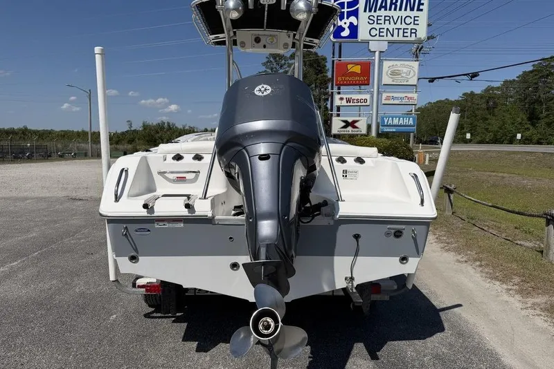 Slide: The Image of Rear view of a 2015 Sea Hunt Ultra 211 boat at a marine service center. - 10