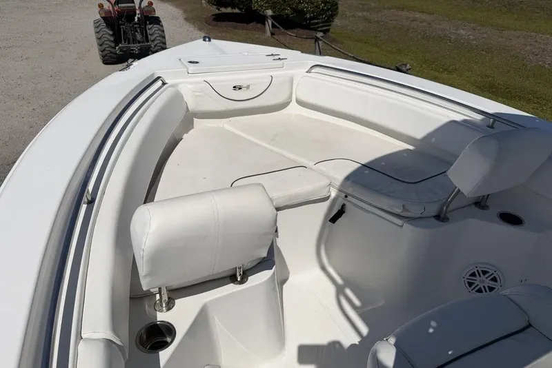 Slide: The Image of 2015 Sea Hunt Ultra 211 boat interior with white seating and cup holders. - 11