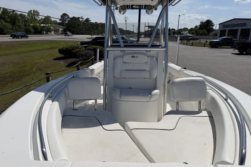 Slide: The Image of 2015 Sea Hunt Ultra 211 boat interior with white seating and console. - 12