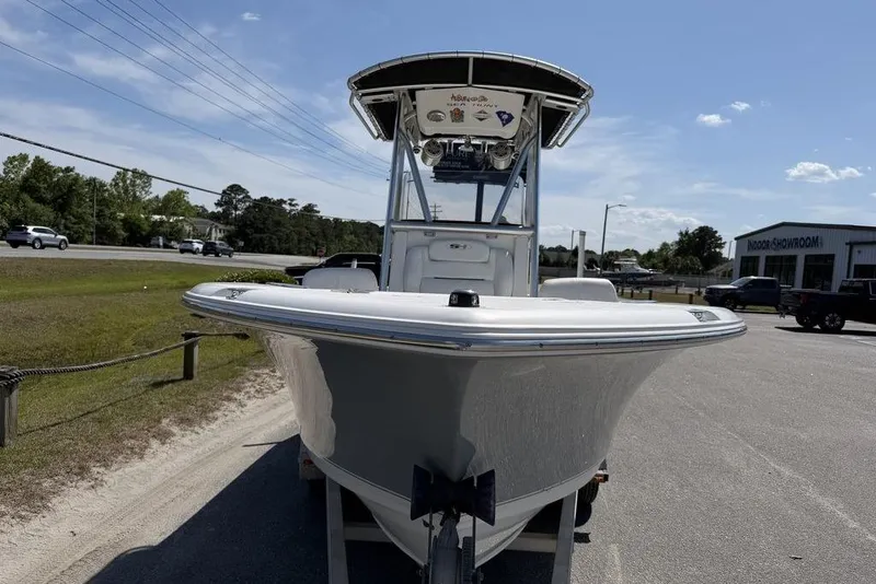Slide: The Image of 2015 Sea Hunt Ultra 211 boat displayed outdoors on a sunny day. - 14