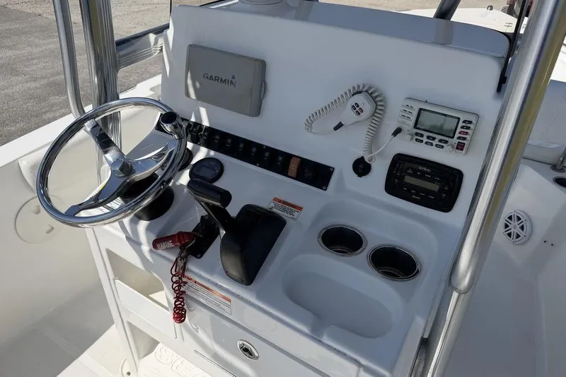 Slide: The Image of 2015 Sea Hunt Ultra 211 boat console with steering wheel and navigation equipment. - 15