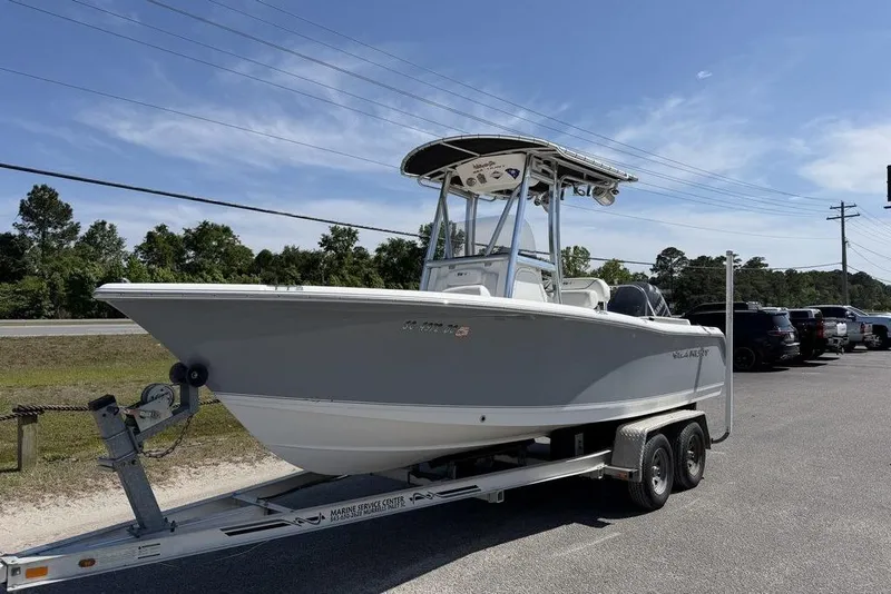 Slide: The Image of 2015 Sea Hunt Ultra 211 boat on trailer under clear sky. - 3