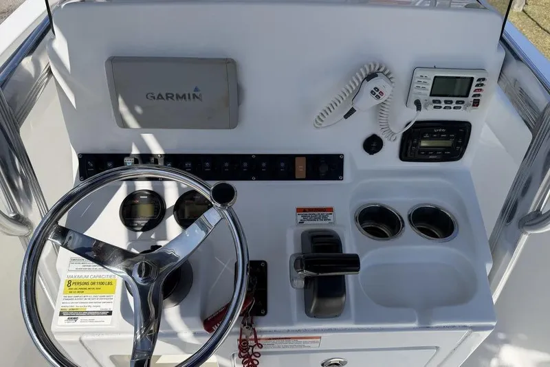 Slide: The Image of 2015 Sea Hunt Ultra 211 boat dashboard with Garmin navigation and control panel. - 6