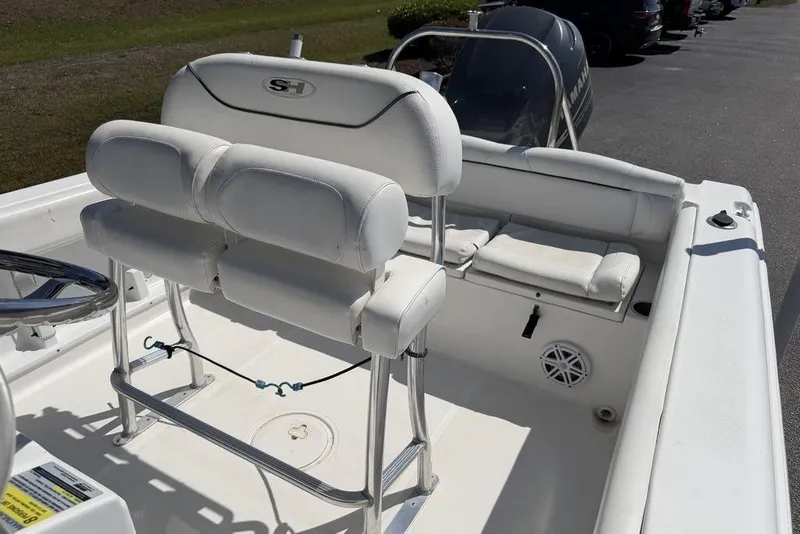 Slide: The Image of 2015 Sea Hunt Ultra 211 boat interior with white seating and steering wheel. - 7