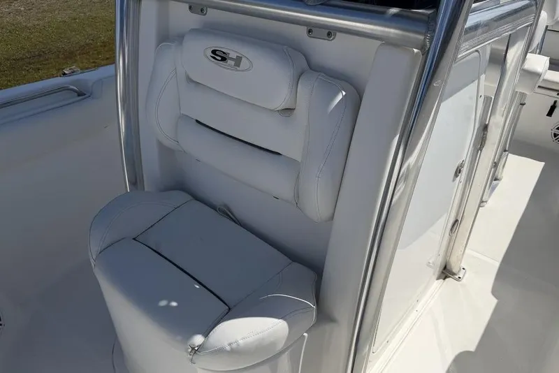 Slide: The Image of 2015 Sea Hunt Ultra 211 boat seat with white upholstery and stainless steel frame. - 8