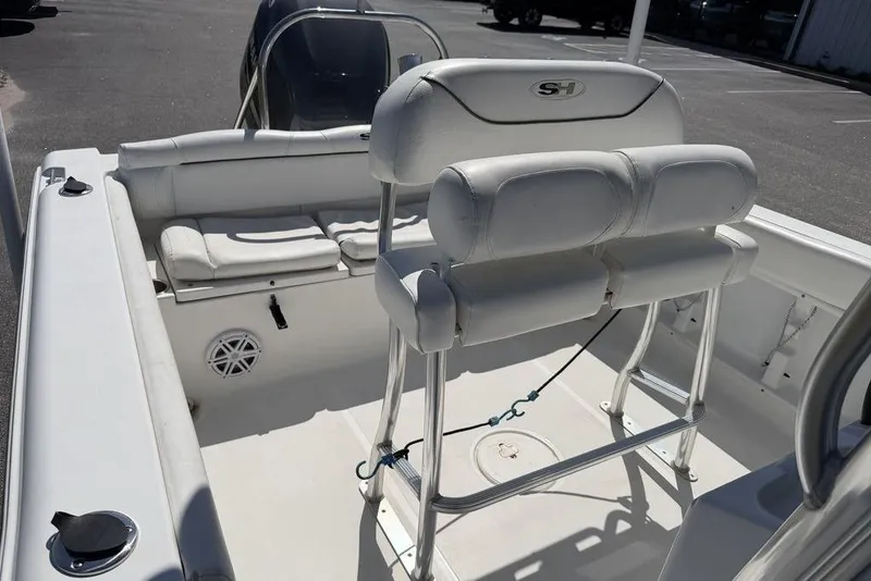 Slide: The Image of 2015 Sea Hunt Ultra 211 boat interior with white seating and console. - 9
