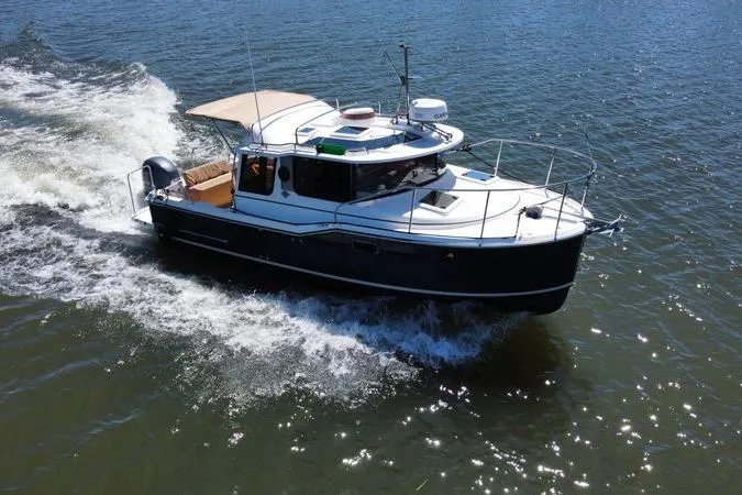 The Image of 2019 Ranger Tugs R-23 cruising on open water, showcasing sleek design and performance. - 1