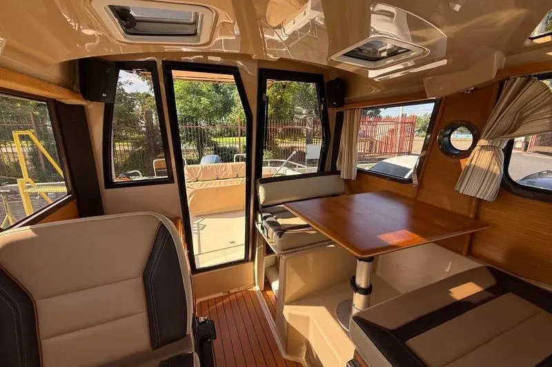 Slide: The Image of Interior of 2019 Ranger Tugs R-23 boat with seating and table. - 12