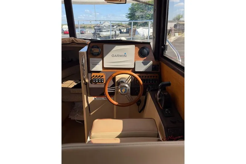 Slide: The Image of 2019 Ranger Tugs R-23 helm with Garmin navigation system and wooden steering wheel. - 8