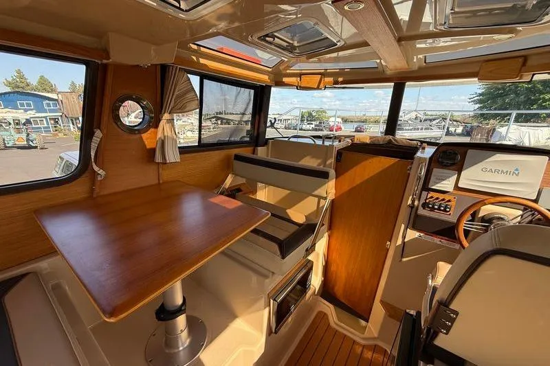 Slide: The Image of Interior of 2019 Ranger Tugs R-23 boat with wooden table and Garmin navigation system. - 9