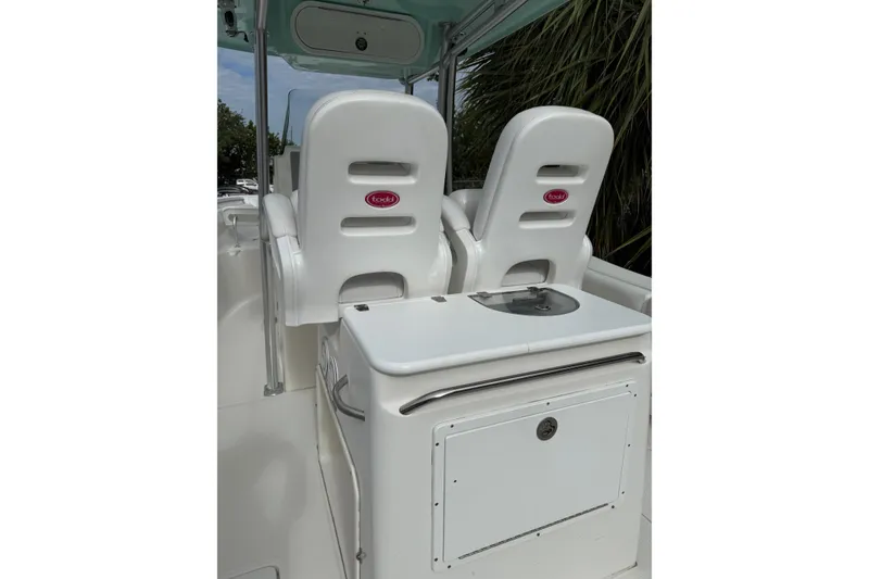 Slide: The Image of 2013 Sea Fox 286 Center Console boat interior with dual white seats and storage compartment. - 11